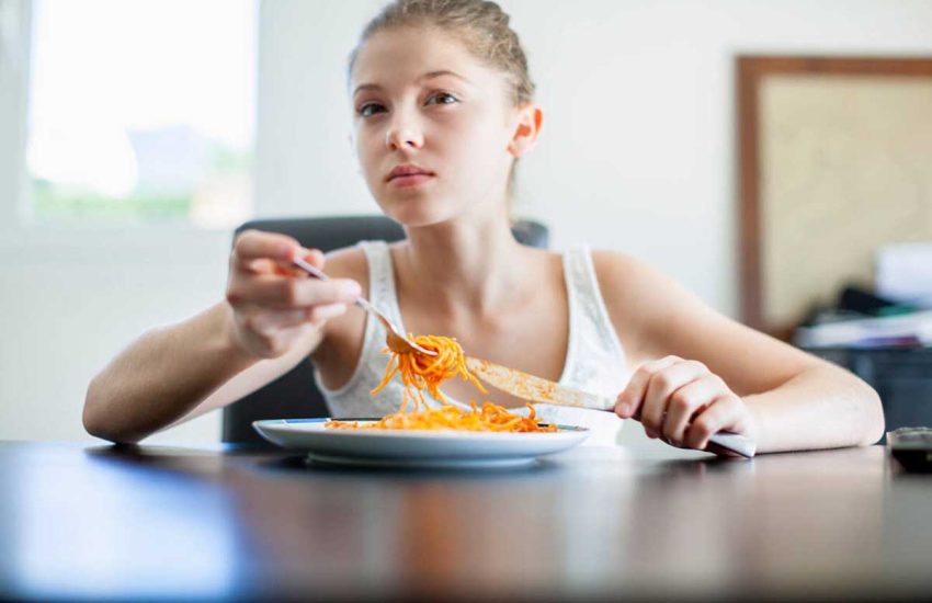 Teenager eating at home